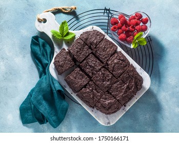 Chocolate Vegan Brownie Pie With Tahini And Fresh Raspberries On A Blue Background