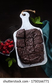 Chocolate Vegan Brownie Pie With Tahini And Fresh Raspberries On A Dark Background