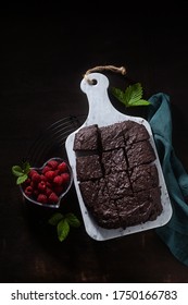 Chocolate Vegan Brownie Pie With Tahini And Fresh Raspberries On A Dark Background