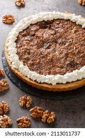 Chocolate Walnut Pie Is Made With Brown Sugar, Corn Syrup And A Hint Of Bourbon Closeup In The Concrete Table. Vertical
