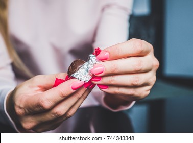 Chocolate In Woman's Hands, Opening Chocolates. A Woman Holds In Her Hand A Chocolat, A Blank, Worn Out Chocolatier, Eating Chocolate, Obesity, Unhealthy Eating, Sweet Food.