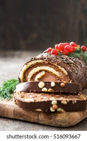 Chocolate yule log christmas cake with red currant on wooden background.copyspace
 - Shutterstock ID 516093667