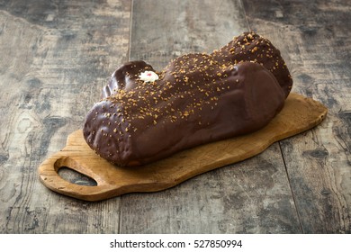 Chocolate yule log christmas cake on wooden background

