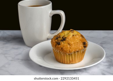 chocolatechip  muffin served with  a cup of coffee