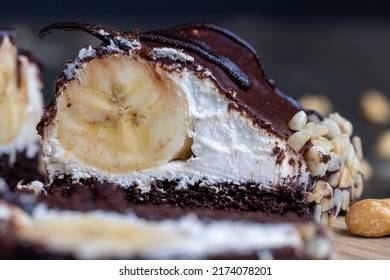 chocolate-drenched banana cake with cheese cream, banana cake in chocolate and peanuts - Shutterstock ID 2174078201