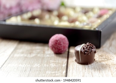 Chocolates on the table. Blurred background. Gift wrap. Wooden background. Close-up. Place for your text. High quality photo