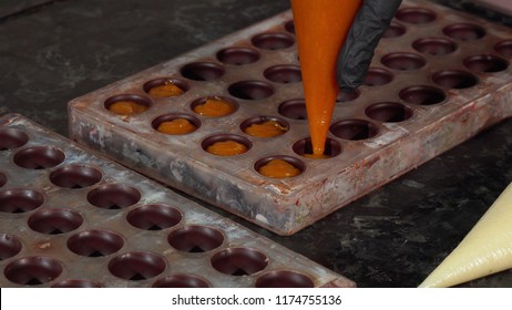 Chocolatier preparing handmade cream filled chocolate candy