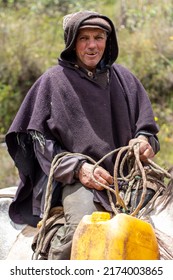 Choconta, Colombia, May 29 2022 : Portait, Typical Rural Scene Of A Colombian Farmer With His Horse On An Earth Path. The Old Man Wears A Wool Traditional Poncho And The Horse Is Harnessed With A Rope