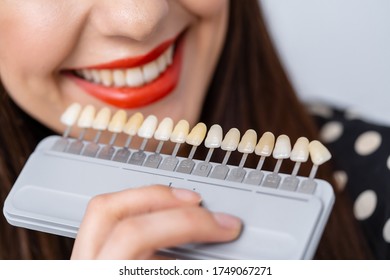 Choice Of Color Of A Dental Artificial Limb At Dental Clinic. Select The Color Of The Teeth In The Dentist Office. Close-up.