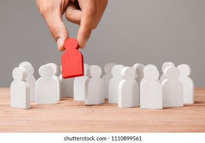 Choice of an employee leader from the crowd. Man holds an employee in his hand. - Shutterstock ID 1110899561