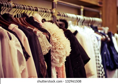 Choice of fashion clothes of different colors on wooden hangers - Shutterstock ID 132961508