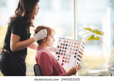 Choice of Hue: Client Ponders Hair Dye Options at Salon for the Perfect Color Transformation - Powered by Shutterstock