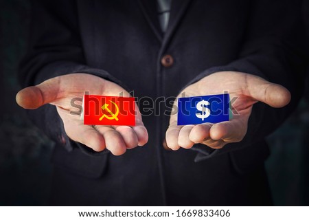 choice of political system is communism or capitalism. sign hammer and sickle or a dollar in the hands. concept of political party elections or misled by the worldwide government.