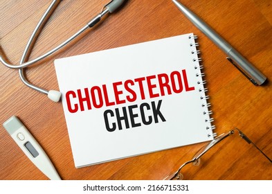 Cholesterol Check With Pen And Stethoscope On Wooden Background