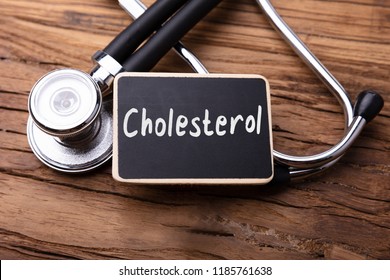 Cholesterol Word Written On Slate With Stethoscope On Wooden Table