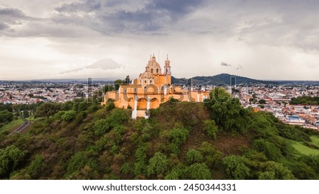 Cholula, Puebla, Mexico, aerial view of the Remedios Church on the top of the great pyramid, Popocatepetl volcano at the background