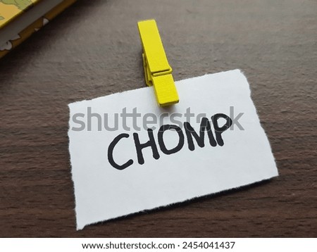 Chomp writting on table background.