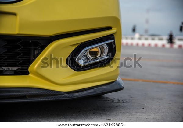 CHONBURI - October\
15: Yellow Car Honda Jazz GK racing car parked on the street. Use\
the Honda logo. Background with car.Honda brand car. October 15,\
2019 in Chonburi,\
Thailand