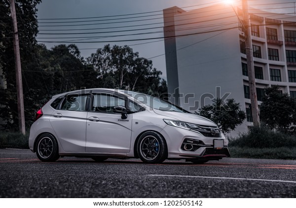 CHONBURI -\
September 16: White Car Honda Jazz GK race car parked on the\
street. Stock photography Space for text. Background with car.\
September 16, 2018 in Chonburi,\
Thailand