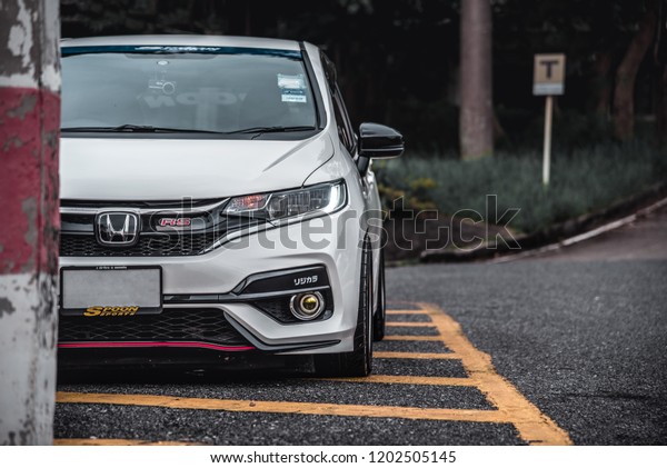 CHONBURI -\
September 16: White Car Honda Jazz GK race car parked on the\
street. Stock photography Space for text. Background with car.\
September 16, 2018 in Chonburi,\
Thailand