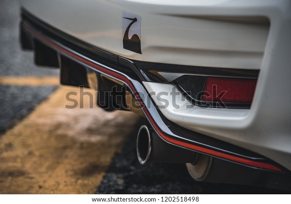 CHONBURI -\
September 16: White Car Honda Jazz GK race car.close up Exhaust\
pipe. Stock photography Space for text. Background with car.\
September 16, 2018 in Chonburi,\
Thailand