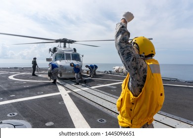 CHONBURI, THAILAND - APRIL 10, 2019: Sailors Are Going To Chalk And Chain A Sikorsky MH-60S Seahawk Helicopter  To The Flight Deck Of The HTMS. Bhumibol Adulyadej Stealth Frigate Of Royal Thai Navy.