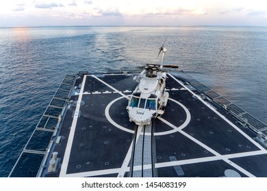 CHONBURI, THAILAND - APRIL 10, 2019:  Sikorsky MH-60S Seahawk Helicopter Lands On The Flight Deck Of The HTMS. Bhumibol Adulyadej Stealth Frigate Of Royal Thai Navy In The Evening