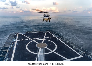 CHONBURI, THAILAND - APRIL 10, 2019:  Sikorsky MH-60S Seahawk Helicopter Prepare To Land On The Flight Deck Of The HTMS. Bhumibol Adulyadej Stealth Frigate Of Royal Thai Navy In The Evening