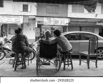 CHONBURI, THAILAND - JULY 5, 2015: Local Thai People Living at Chonburi, Thailand on Jul 5, 2015. Grown up child normally take care parent till death though they married. Black&White Photoshop Filter.