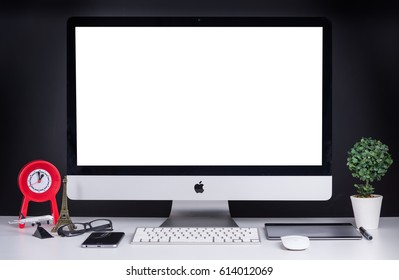 CHONBURI, THAILAND - MARCH 12, 2017: IMac Monitor Computers, IPhone, Keyboard And Magic Mouse On White Desk, Created By Apple Inc.