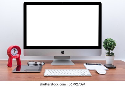 CHONBURI, THAILAND - OCTOBER 30, 2016: iMac monitor computers and keyboard with iPhone, magic mouse and iPad on wooden desk