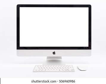 CHONBURI, THAILAND - SEPTEMBER 25, 2016: iMac monitor digital computers desktop mockup, keyboard and magic mouse on white desk table, created by Apple Inc.