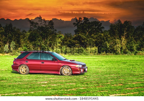 Chonburi/Thailand- March 11,2020: Photography of 1997\
Subaru suv  model Impreza parking at the road on a country road in\
a forest while traveling\
.