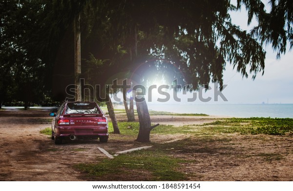 Chonburi/Thailand- March 11,2020: Photography of 1997\
Subaru suv  model Impreza parking at the road on a country road in\
a forest while traveling\
.