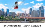 A Chongqing cable car crosses the Yangtze River from Yuzhong District, passing the Dongshuimen bridge - words on cable car translates as 