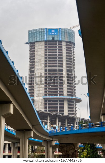Chongqing, China - Dec 20, 2019: Skyscraper in\
construction view from under\
flyover