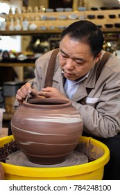 Chongqing / China - December 22 2017: This Picture Depicts A Local Chinese Potter Working On His Masterpiece In One Of The Souvenir Shops In Ciqikou Ancient Market