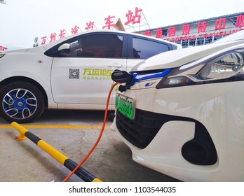 Chongqing, China – May 28, 2018: New Energy Electric Vehicle, New Energy Vehicle Charging At Charging Station Using Charging Pole