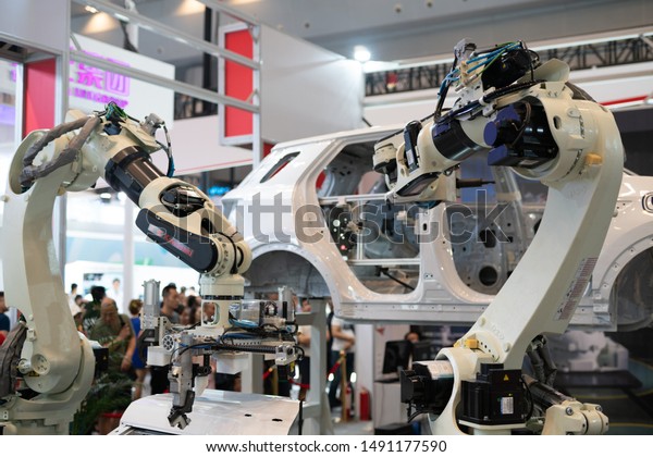 Chongqing,China-August,29th 2019:Robot arm\
assemble car display in Smart China expo. China is developing its\
technology in robot industry and applicate in car\
industry.