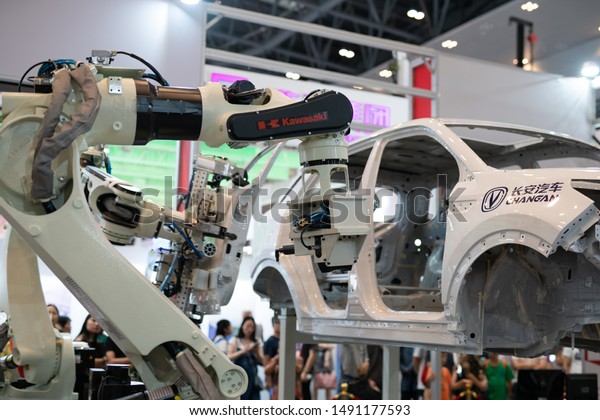 Chongqing,China-August,29th 2019:Robot arm\
assemble car display in Smart China expo. China is developing its\
technology in robot industry and applicate in car\
industry.