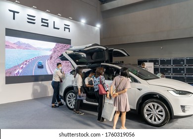 Chongqing,China-June 20, 2020:  Tesla Model X Displayed In China Auto Expo During Covid19 Pandemic. Staff Wearing Face Mask .