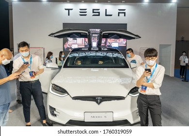 Chongqing,China-June 20, 2020:  Tesla Model X Displayed In China Auto Expo During Covid19 Pandemic. Staff Wearing Face Mask .