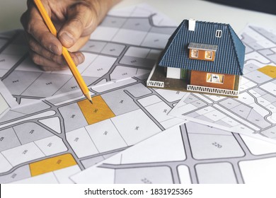 choose a building plot of land for house construction on cadastral map - Shutterstock ID 1831925365