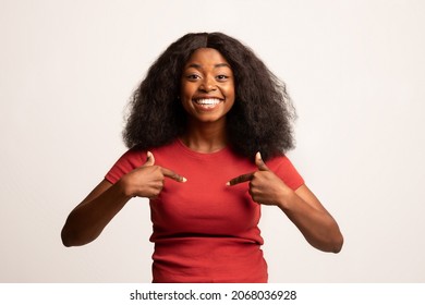Choose Me. Portrait Of Happy Excited African American Woman Pointing At Herself With Two Hands And Looking At Camera, Positive Young Black Lady Posing Over White Studio Background, Copy Space