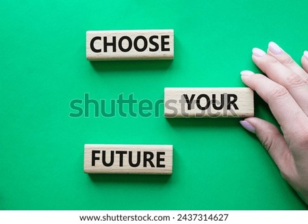 Choose your future symbol. Wooden blocks with words Choose your future. Beautiful green background. Businessman hand. Business and Choose your future concept. Copy space.