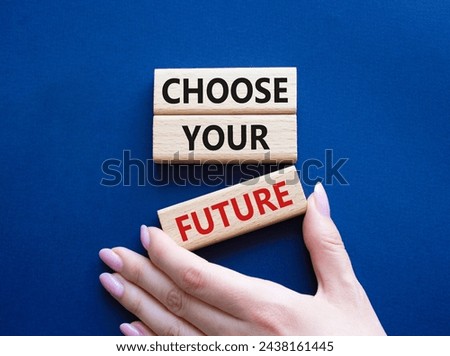 Choose your future symbol. Wooden blocks with words Choose your future. Beautiful deep blue background. Businessman hand. Business and Choose your future concept. Copy space.