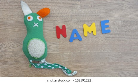 Choosing Baby Name Written With Wooden Letters