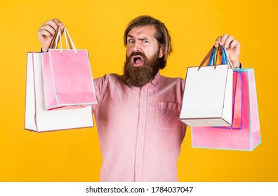Choosing the best. surprised male open shopping bag with something exciting inside. mature man looking casual in surprise with present package. commonly used for birthday. buy anniversary gifts.