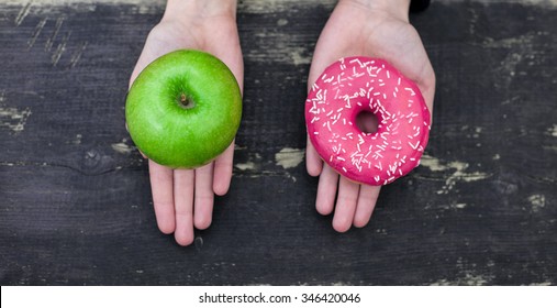 Choosing between apple and donut - Shutterstock ID 346420046