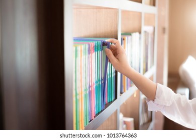 Choosing A Book In The Library.